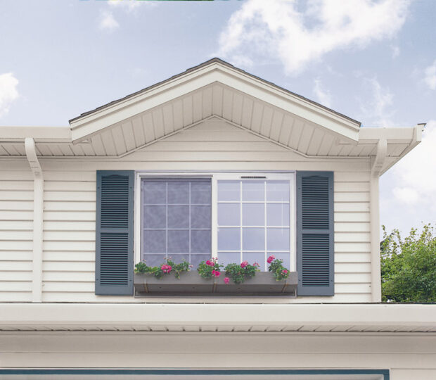 House window with blue shutters and flower box.