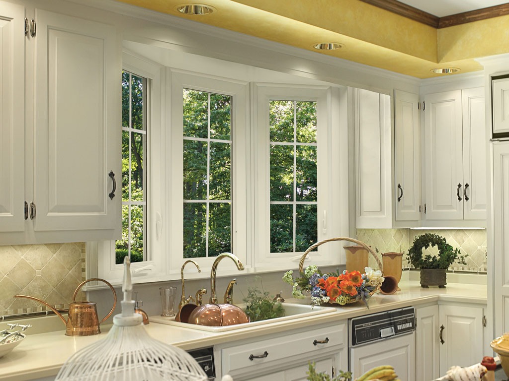 Bright kitchen with large bay window and plants.